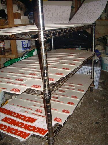 Screen prints drying on racks in the studio at Islington Mill