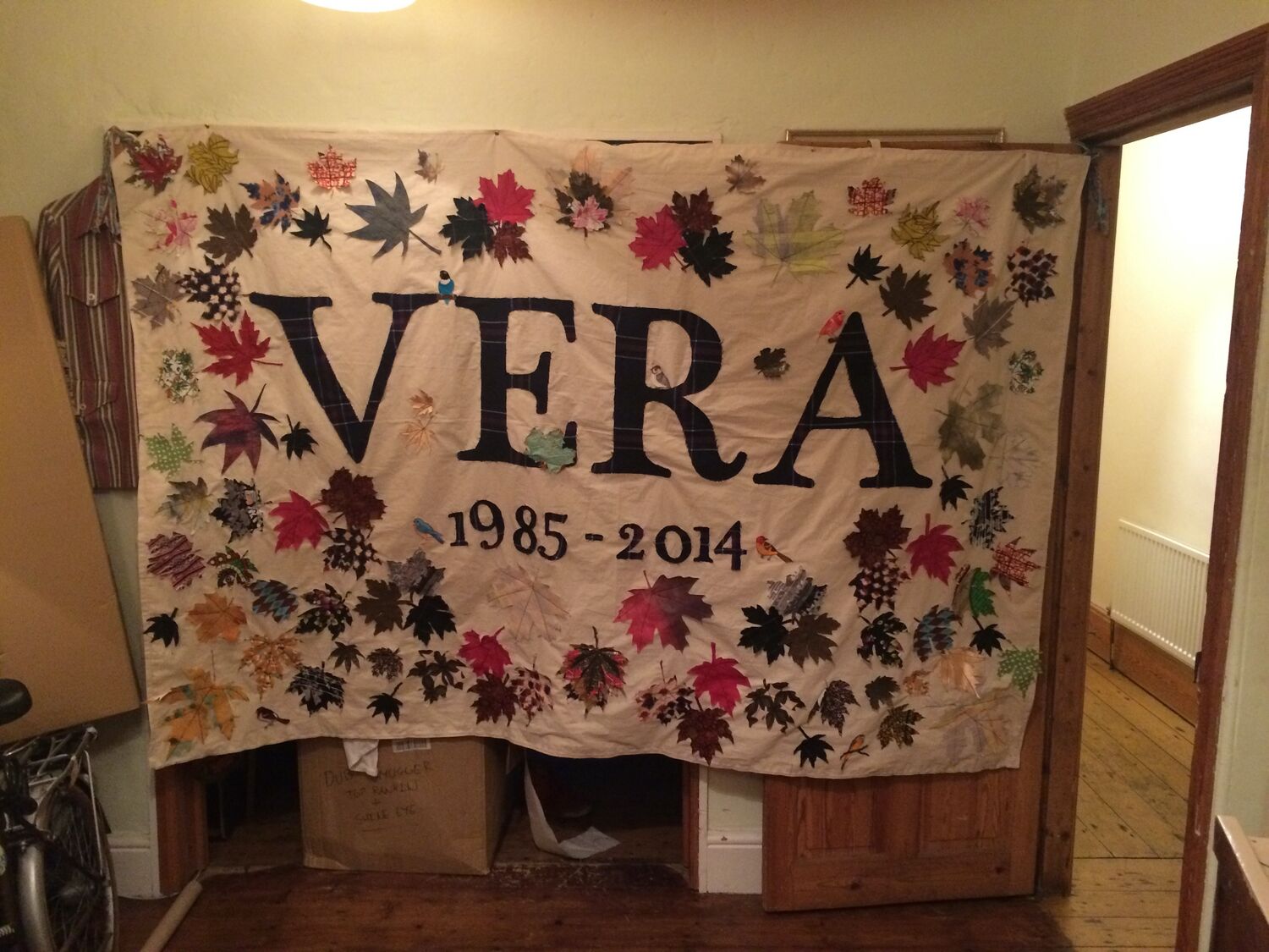 The banner made for Vera, reading VERA 1985 to 2014, ringed with fabric leaves