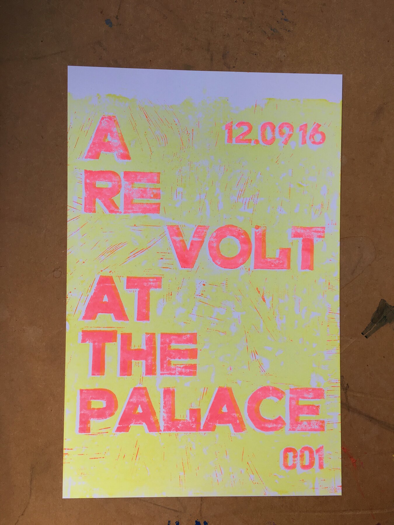 Layered lino-cut poster reading A Re Volt at the Palace, edition 001, drying in the studio