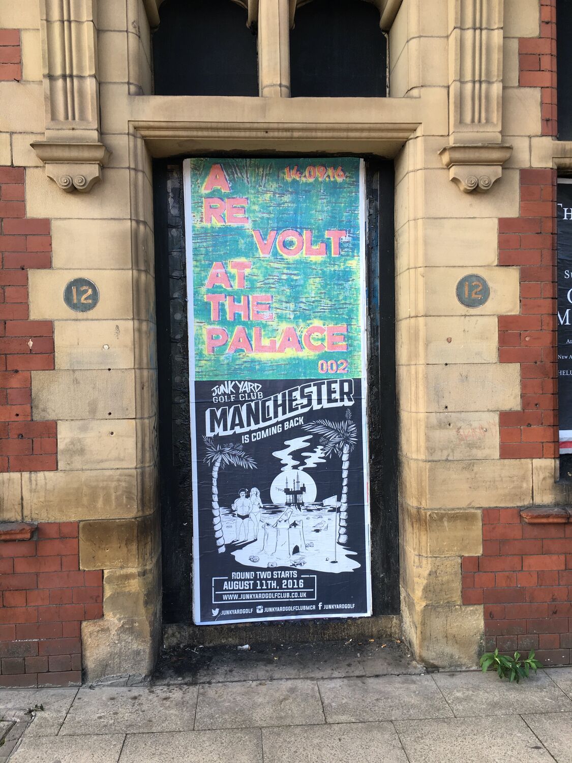 A Revolt at the Palace poster pasted in a Manchester doorway
