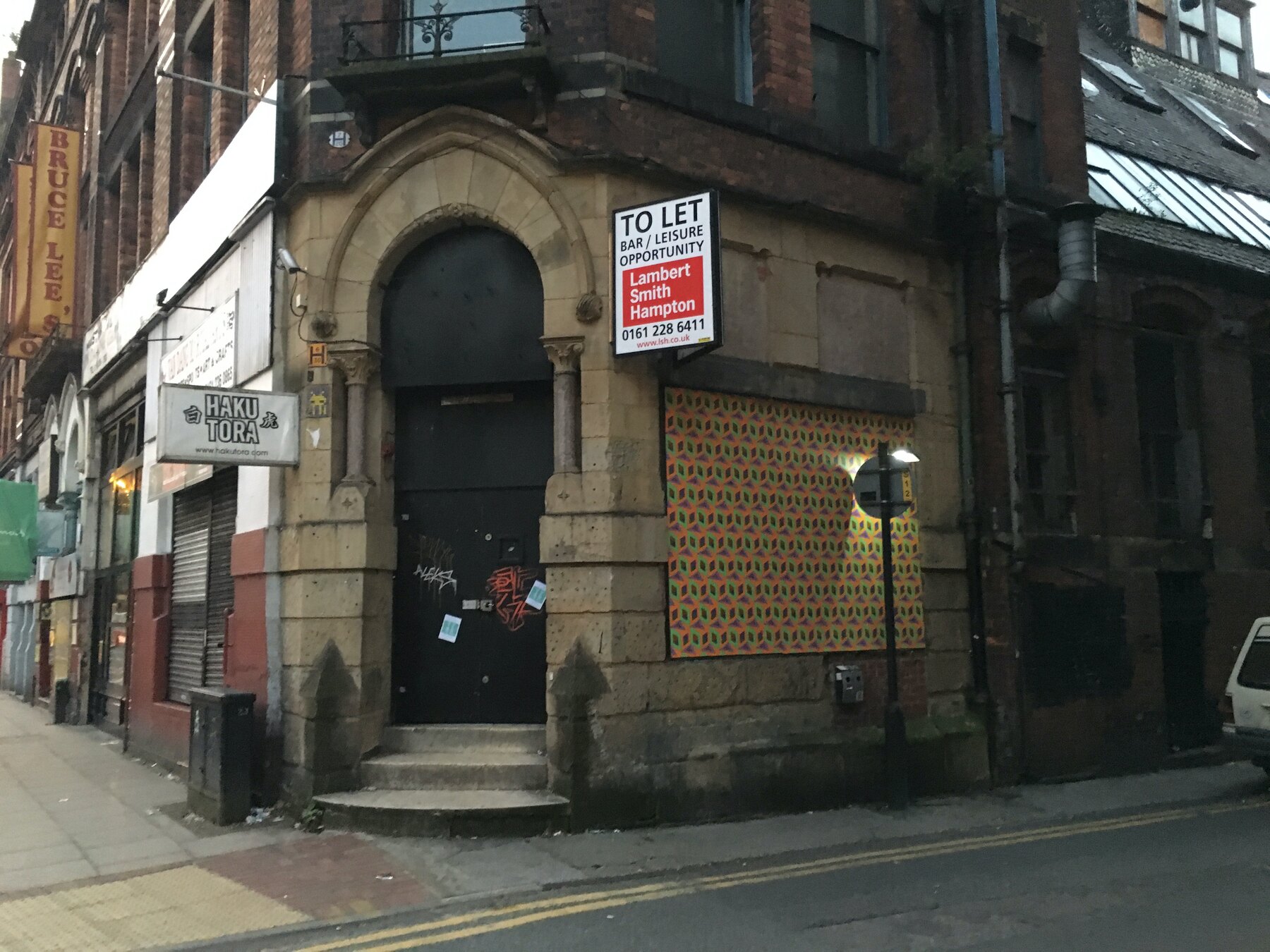 Hand-printed wallpaper installed on the boarded windows of the old Roadhouse, Newton Street, Manchester