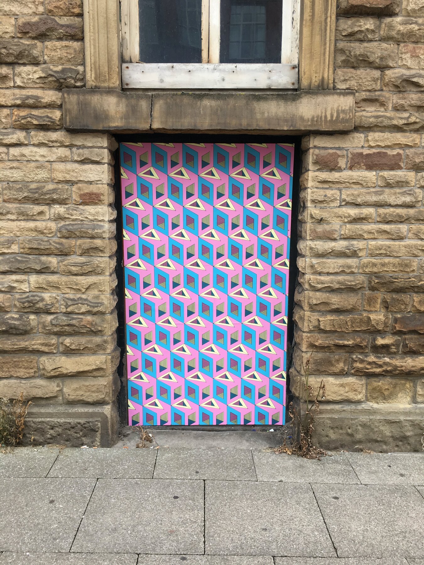 Pink and blue wallpaper installed over doorways near London Road, Manchester
