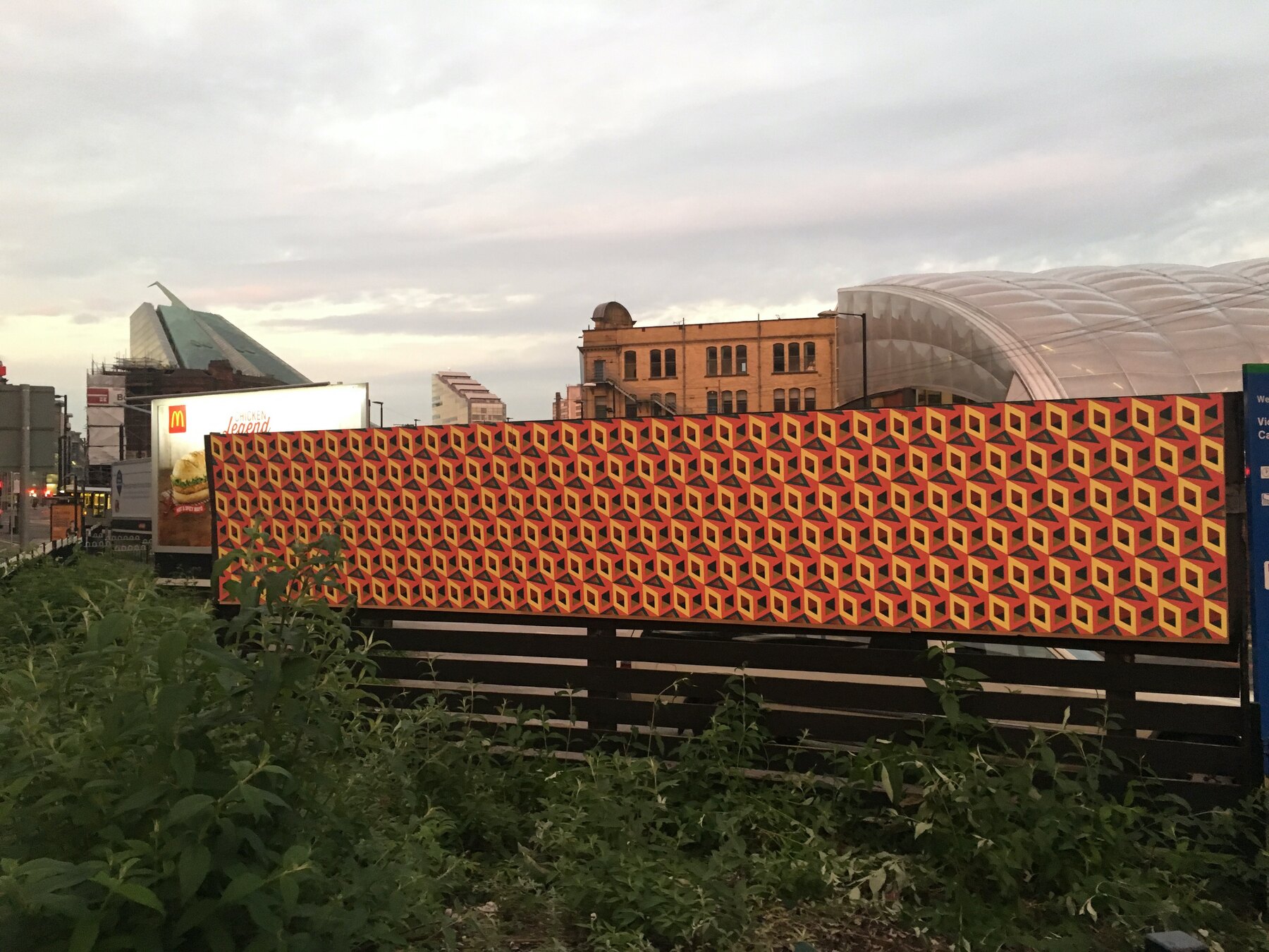Orange wallpaper along the fence line by Victoria Station at dawn