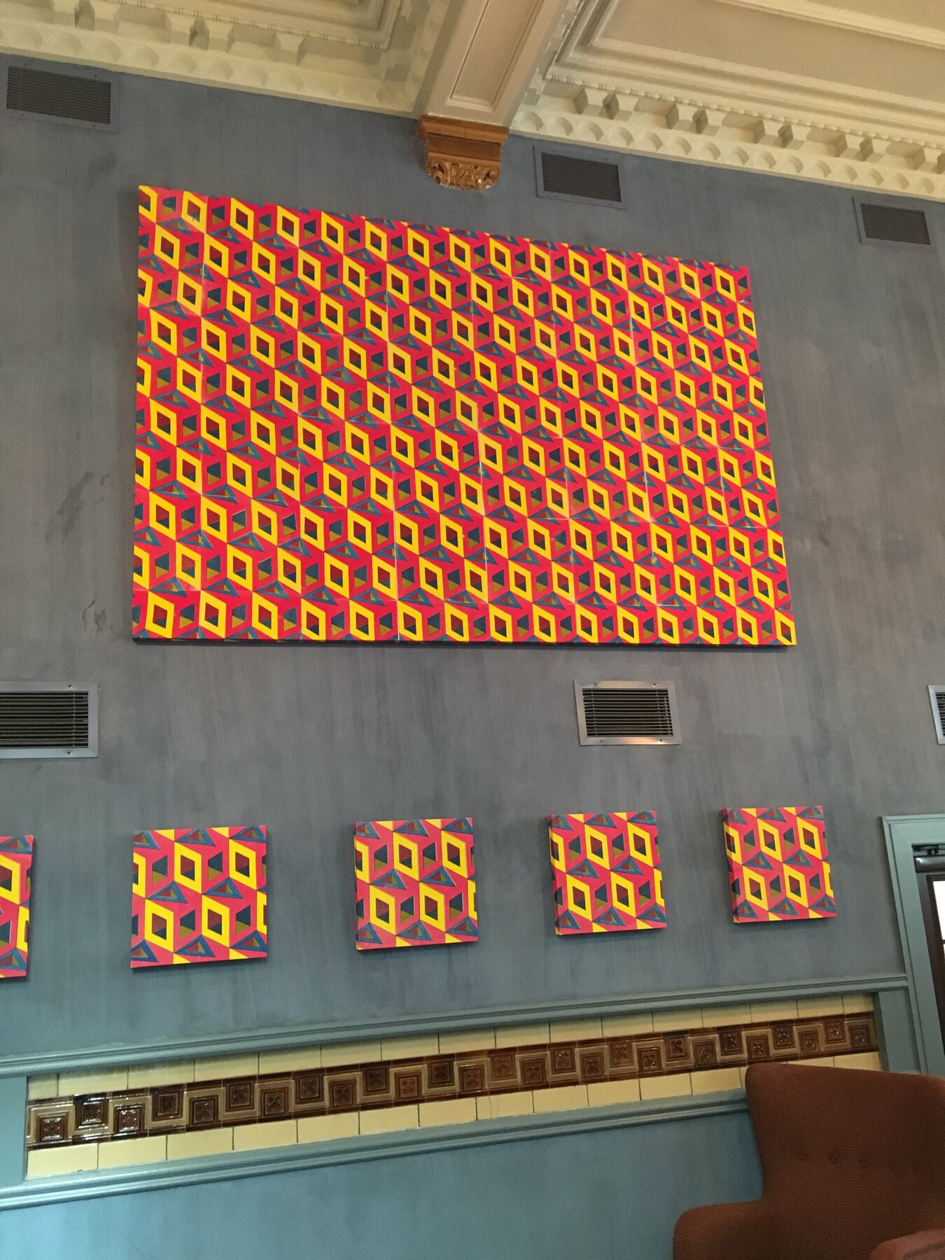 Screen-printed canvases hung high in the long dining room at the Refuge