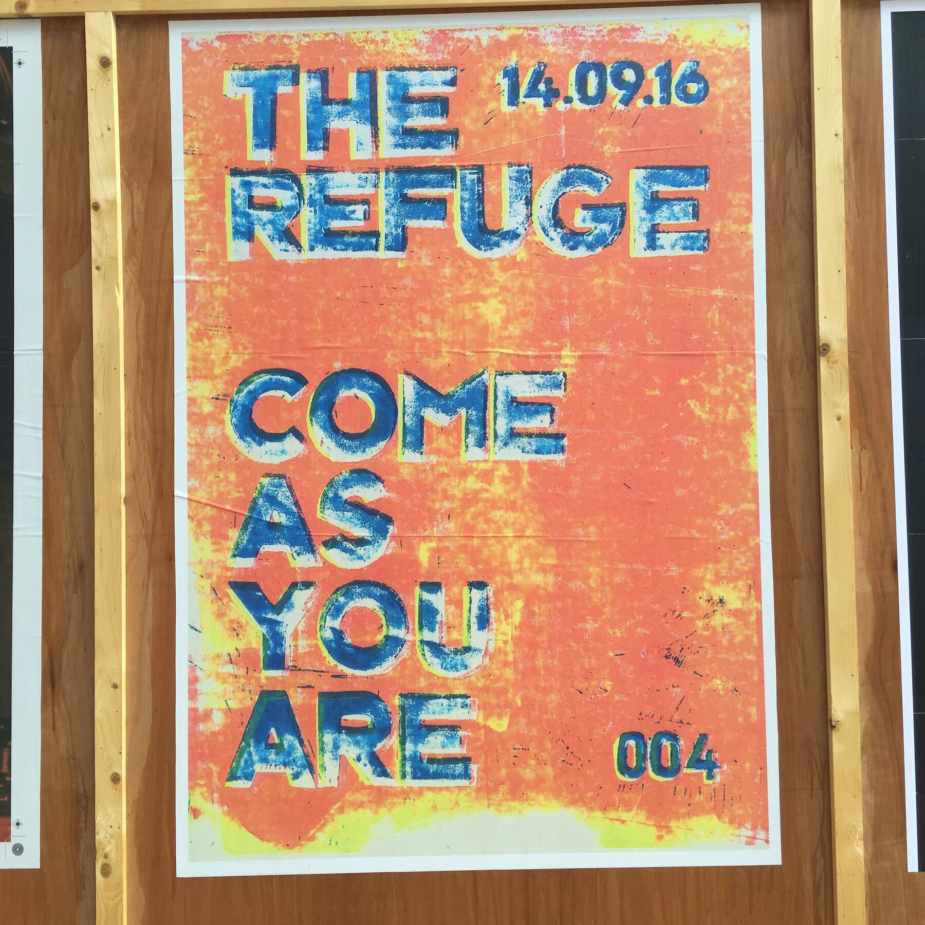 Hand-printed poster reading The Refuge, Come As You Are, edition 004, pasted on a Manchester hoarding