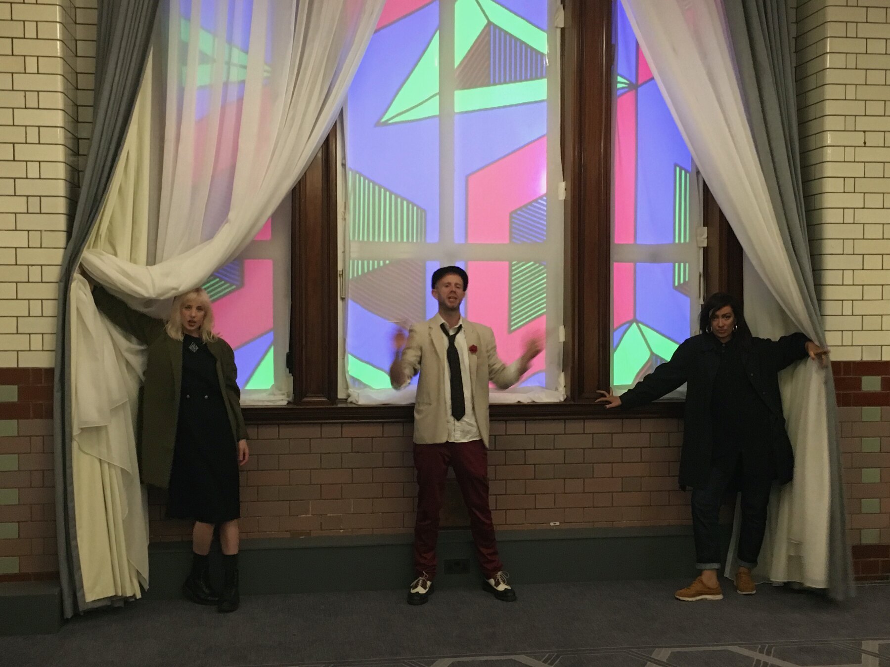 Mark beneath his patterns projected across the arched windows at the Refuge launch