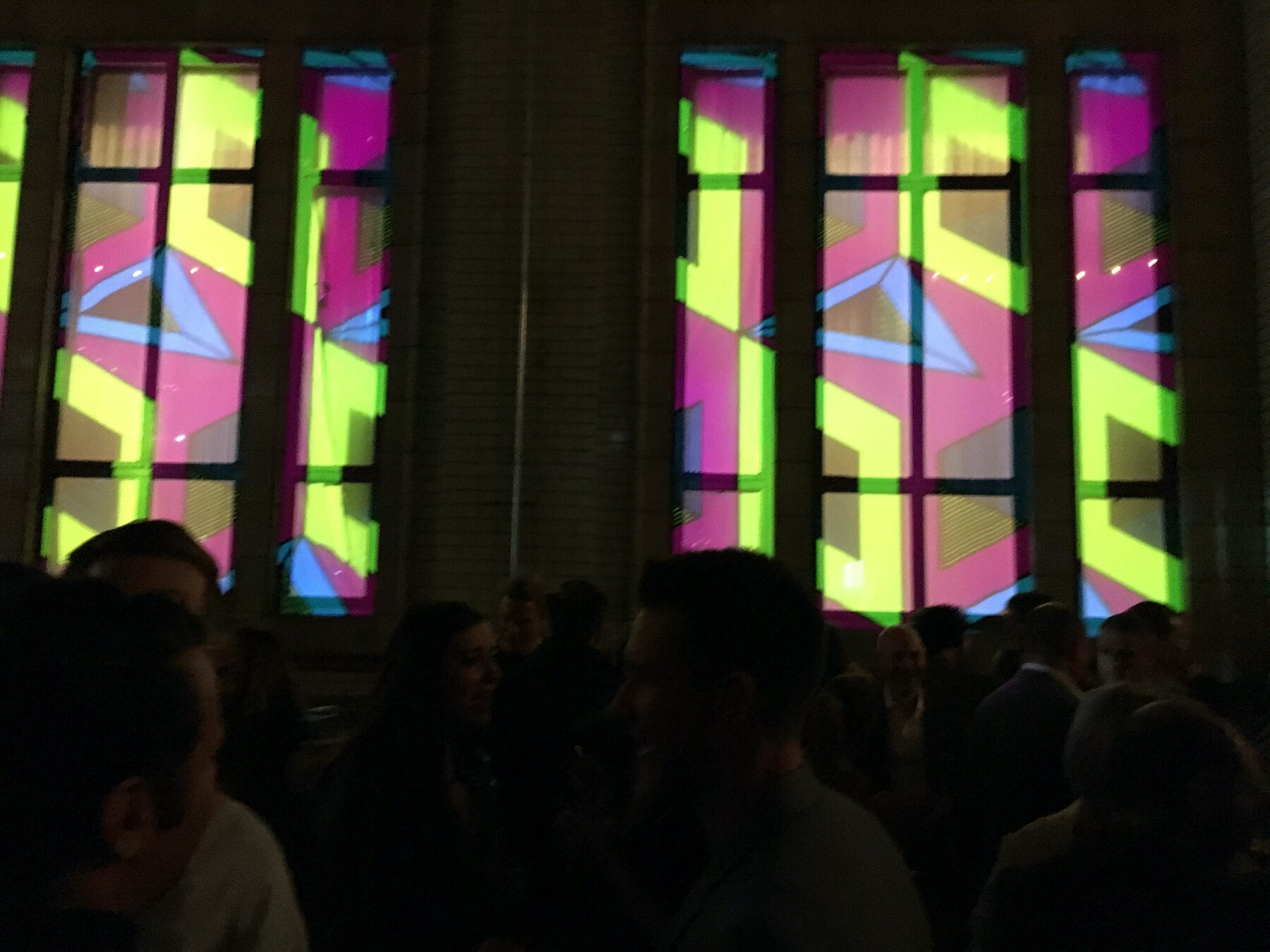 The Refuge launch night, patterns projected over the windows above the crowd