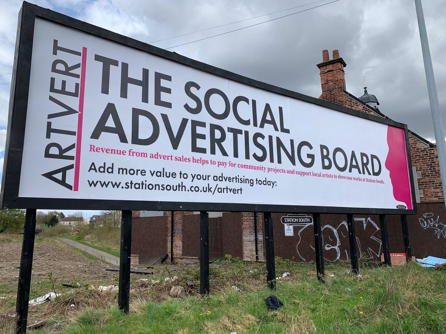 The Artvert social advertising board at Station South, Levenshulme, reading The Social Advertising Board