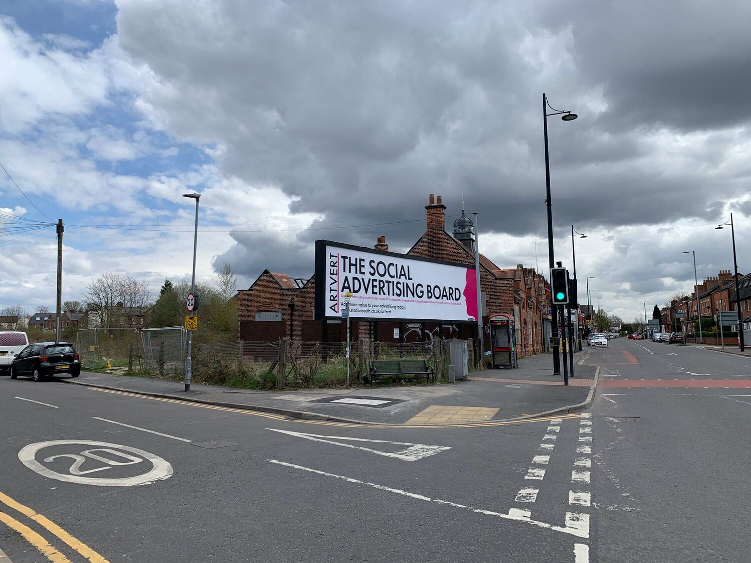 The Artvert board on the Station South site in Levenshulme, seen down the terraced streets