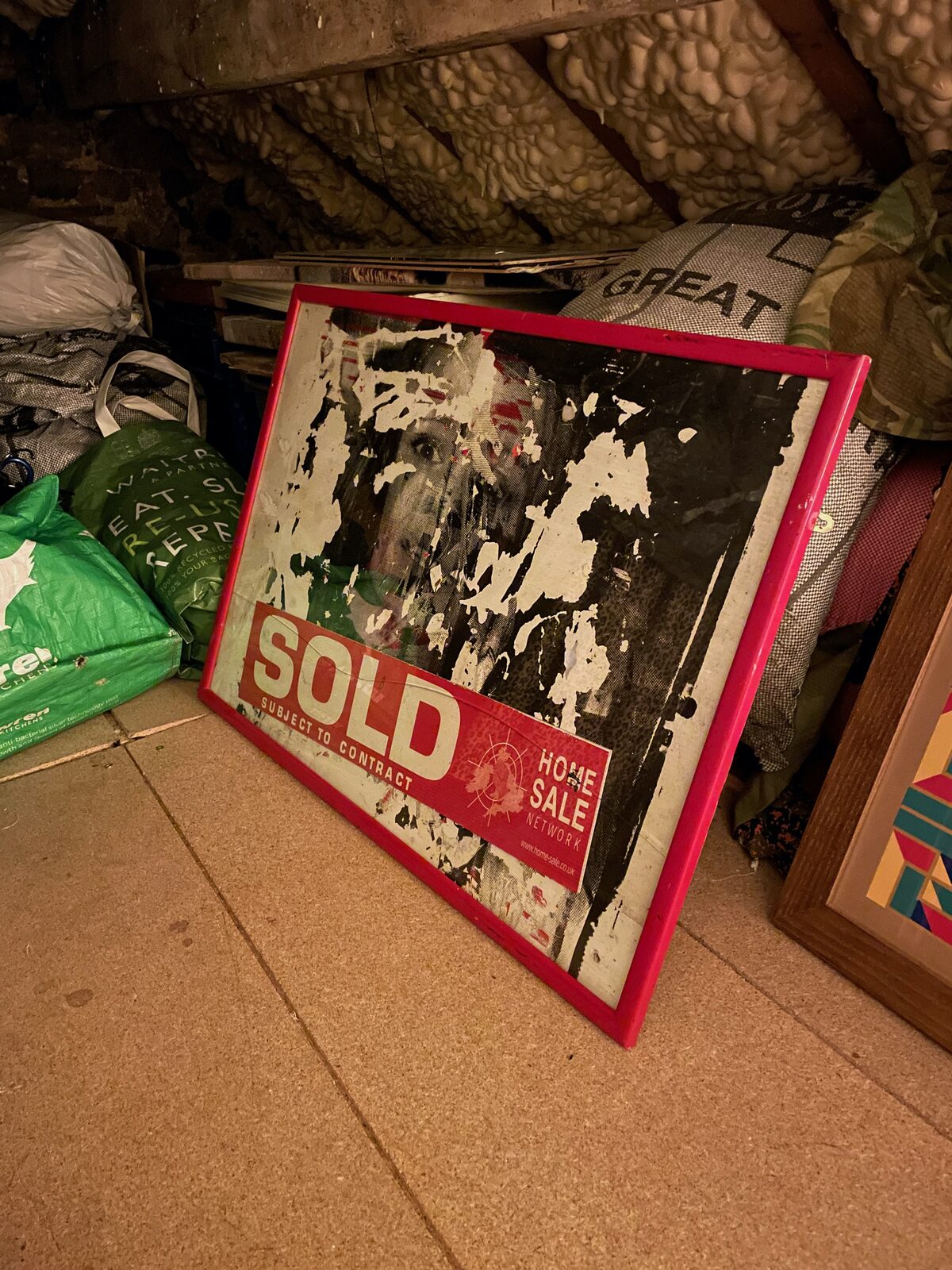 A framed piece among the stored work in the one69a archive.