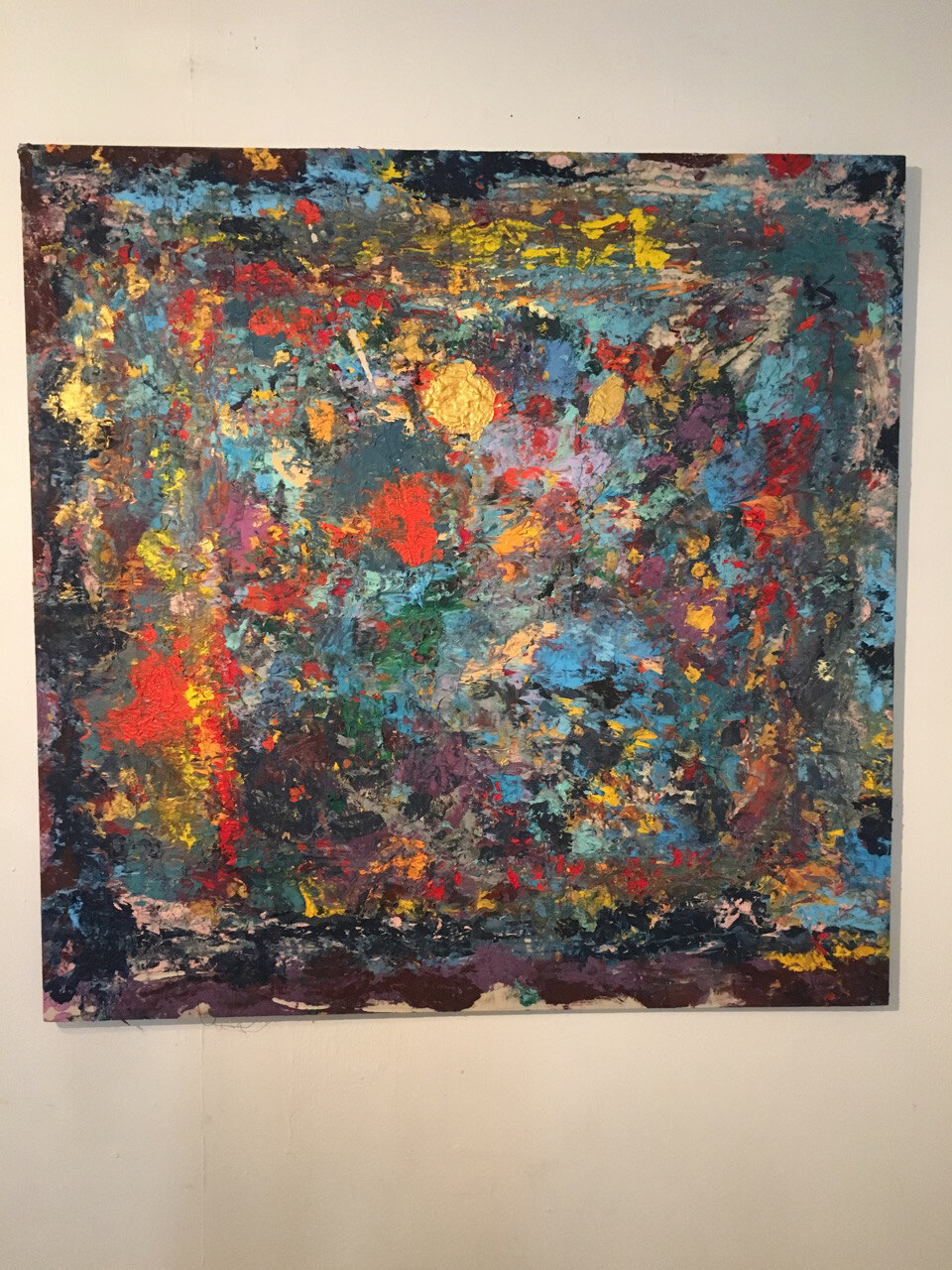 Close view of a painting in deep blue, red and gold, part of the David Bowie series