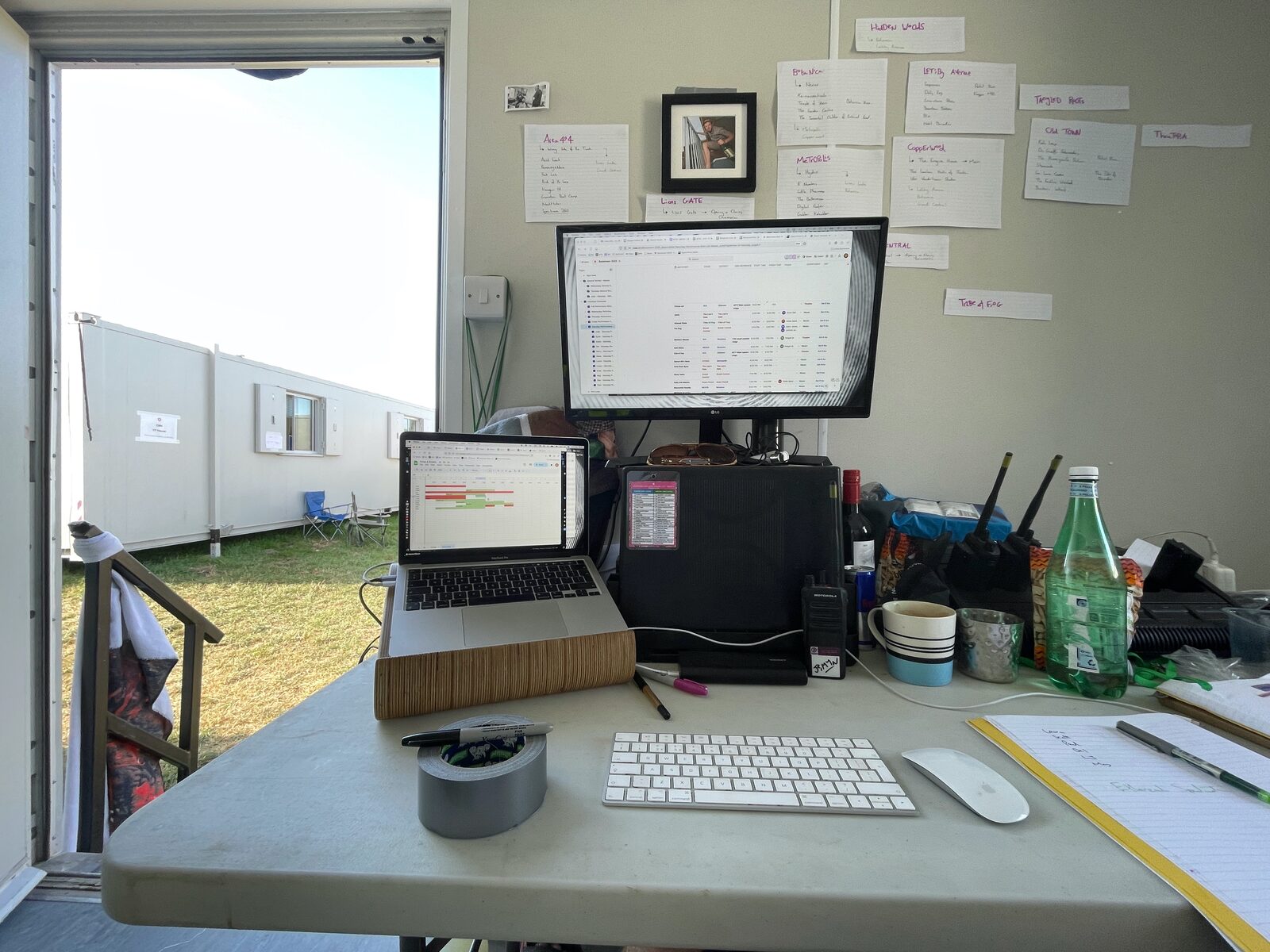 Boomtown photography production office: dual monitors, laptop and site maps in a portacabin on site.