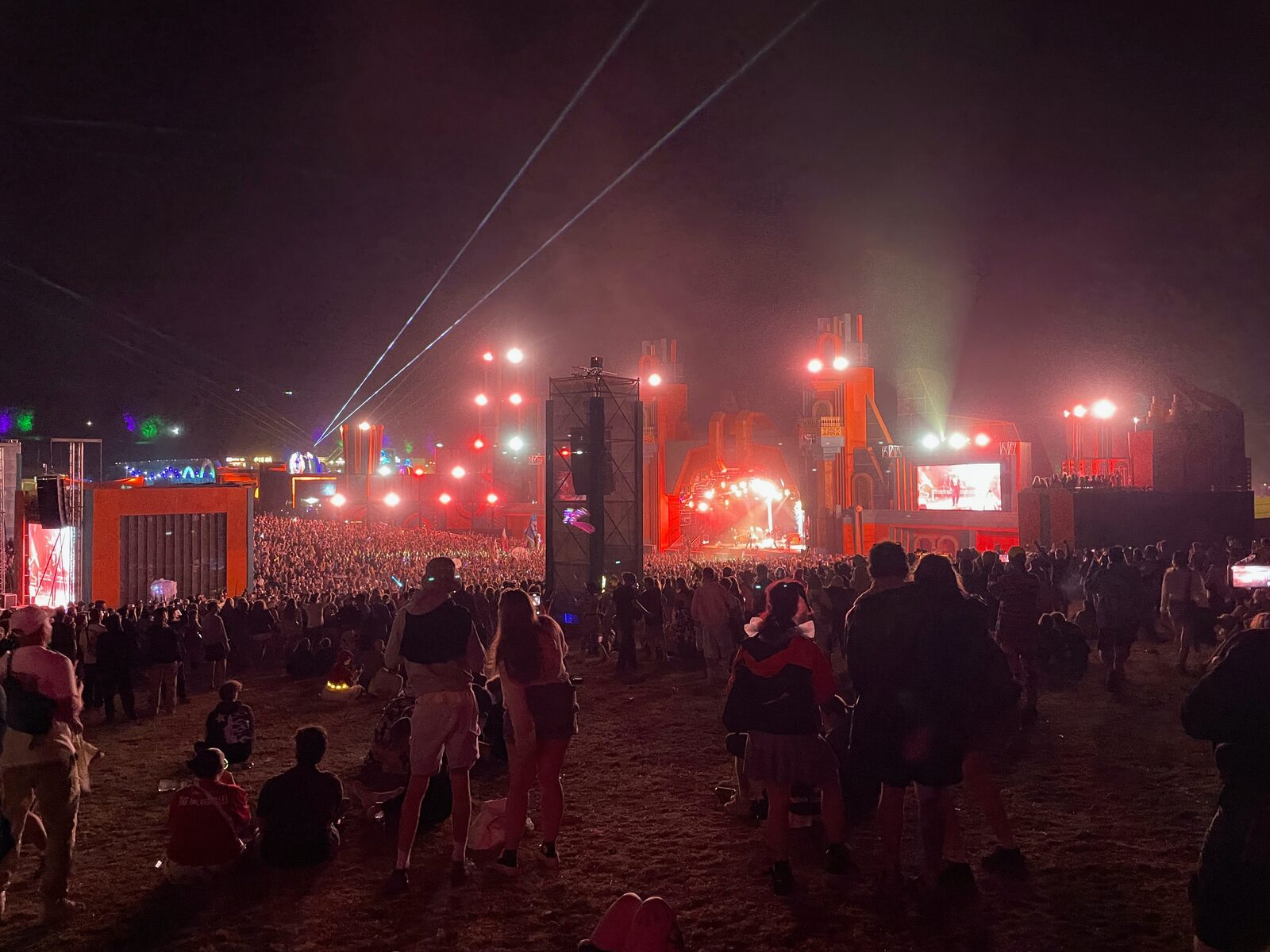 A Boomtown main stage at night, lit for the crowd.