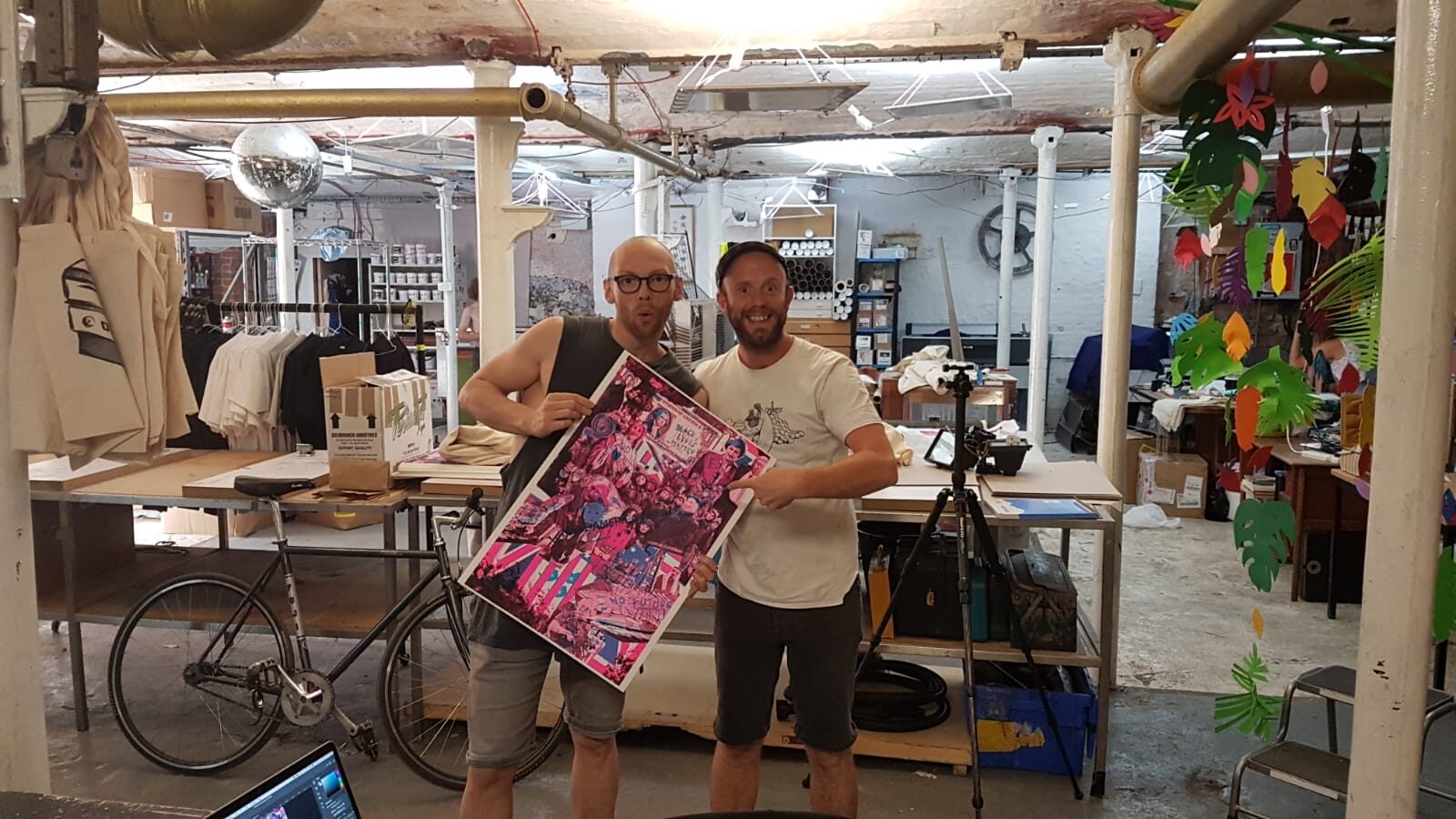 Mark Jermyn and Cheddar Gorgeous holding a printed proof of the pattern in the print workshop