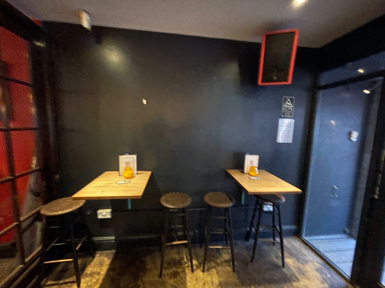 A corner of Electrik with tables and drinks.