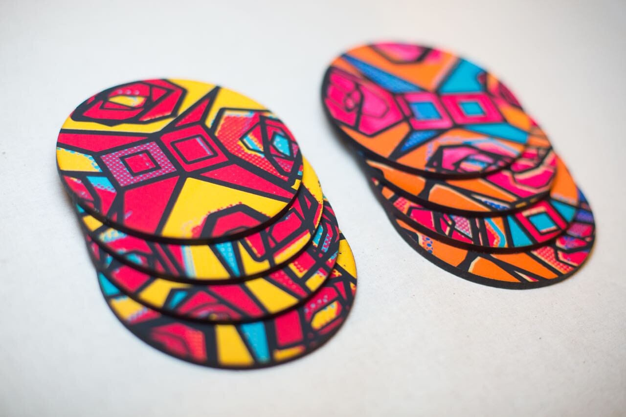 A stack of round coasters printed with the Kath Kidston on Acid pattern