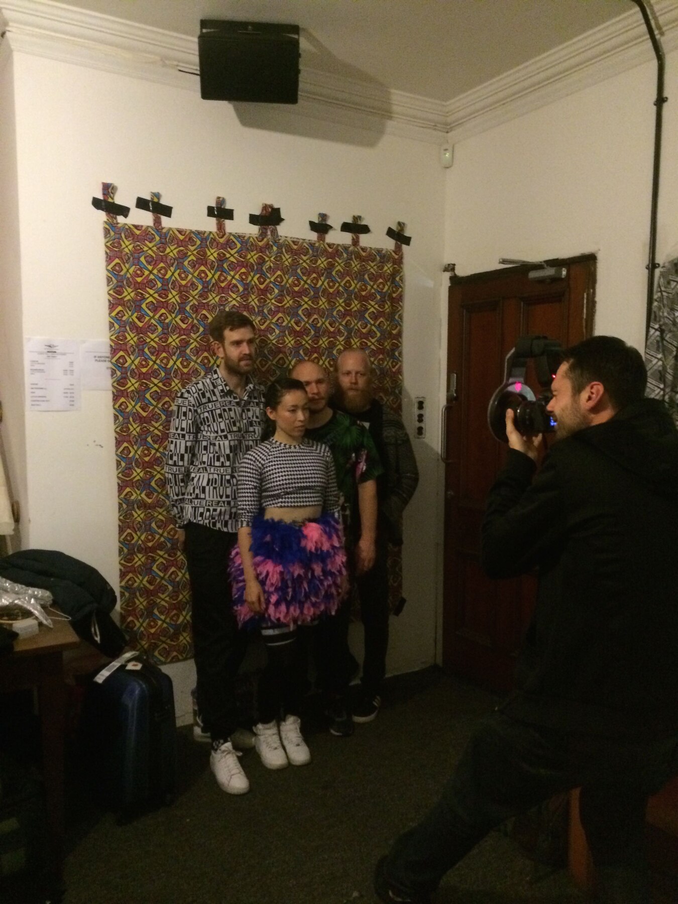 Little Dragon posed in front of the pattern backdrop during the photoshoot, being photographed