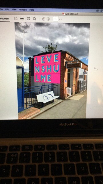 A design proposal for the Levenshulme Station Mural composited onto a photograph of the platform building