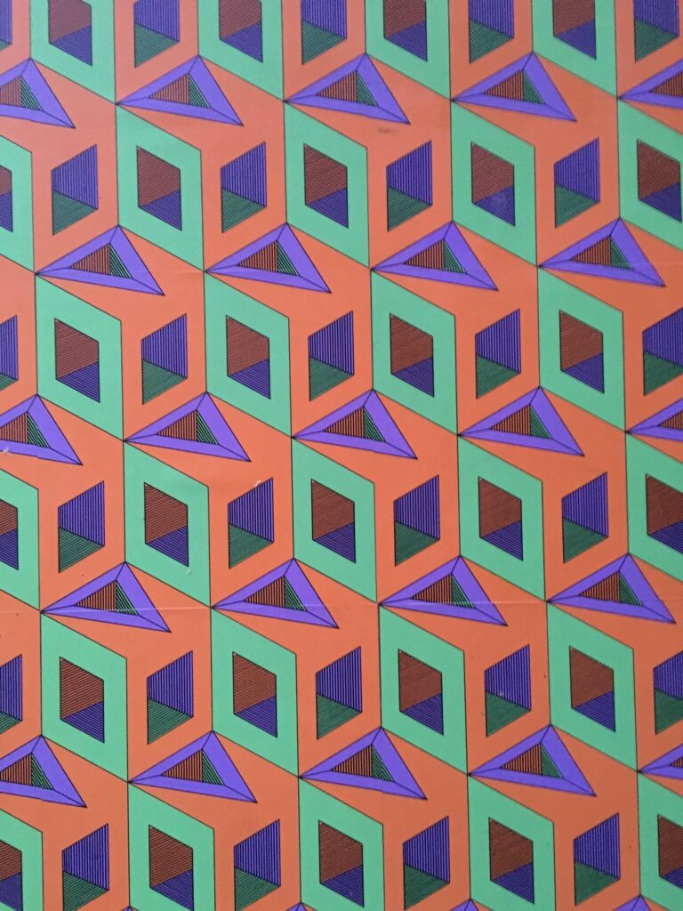 The pattern as wallpaper, in a blue and yellow colourway
