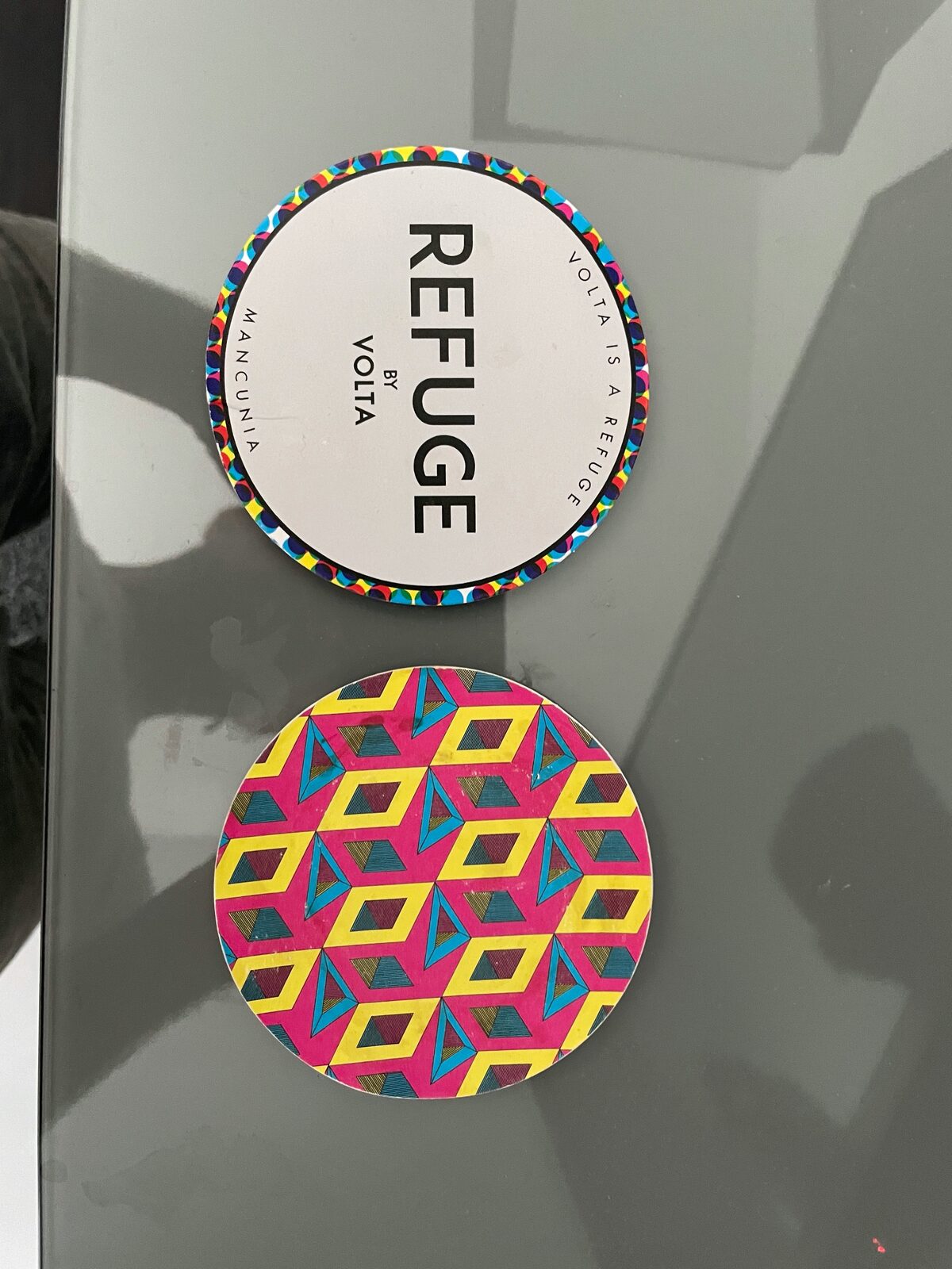 Refuge coasters showing the wordmark and pattern