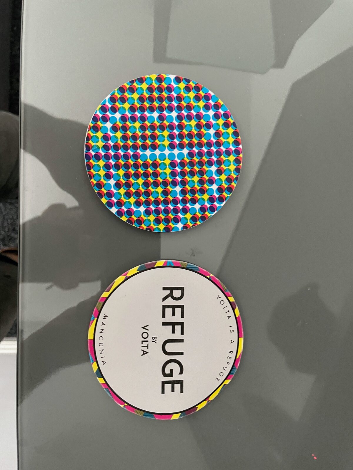 Refuge coasters showing the pattern and wordmark