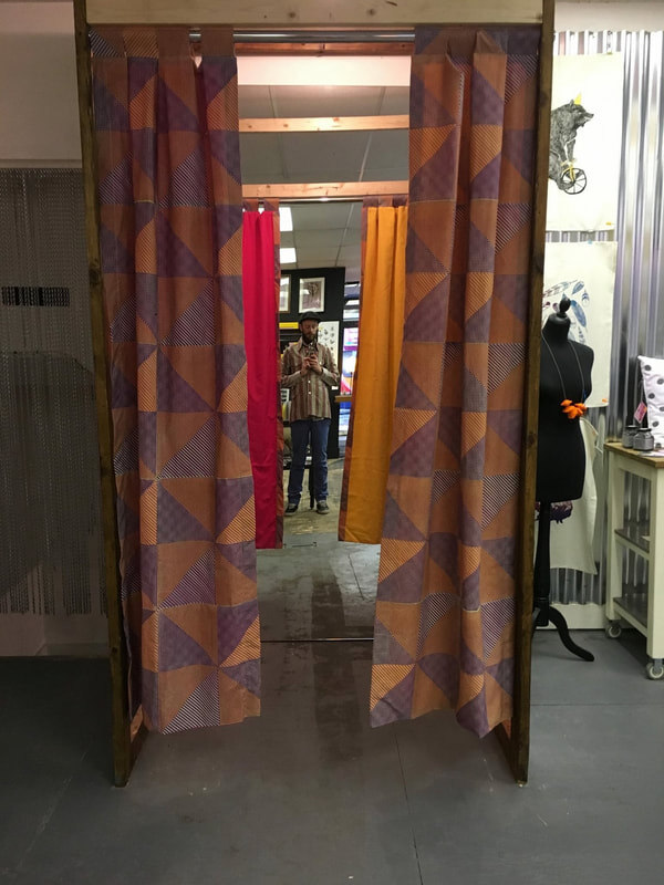 Custom curtains marking the entrance to the dressing room inside the shop