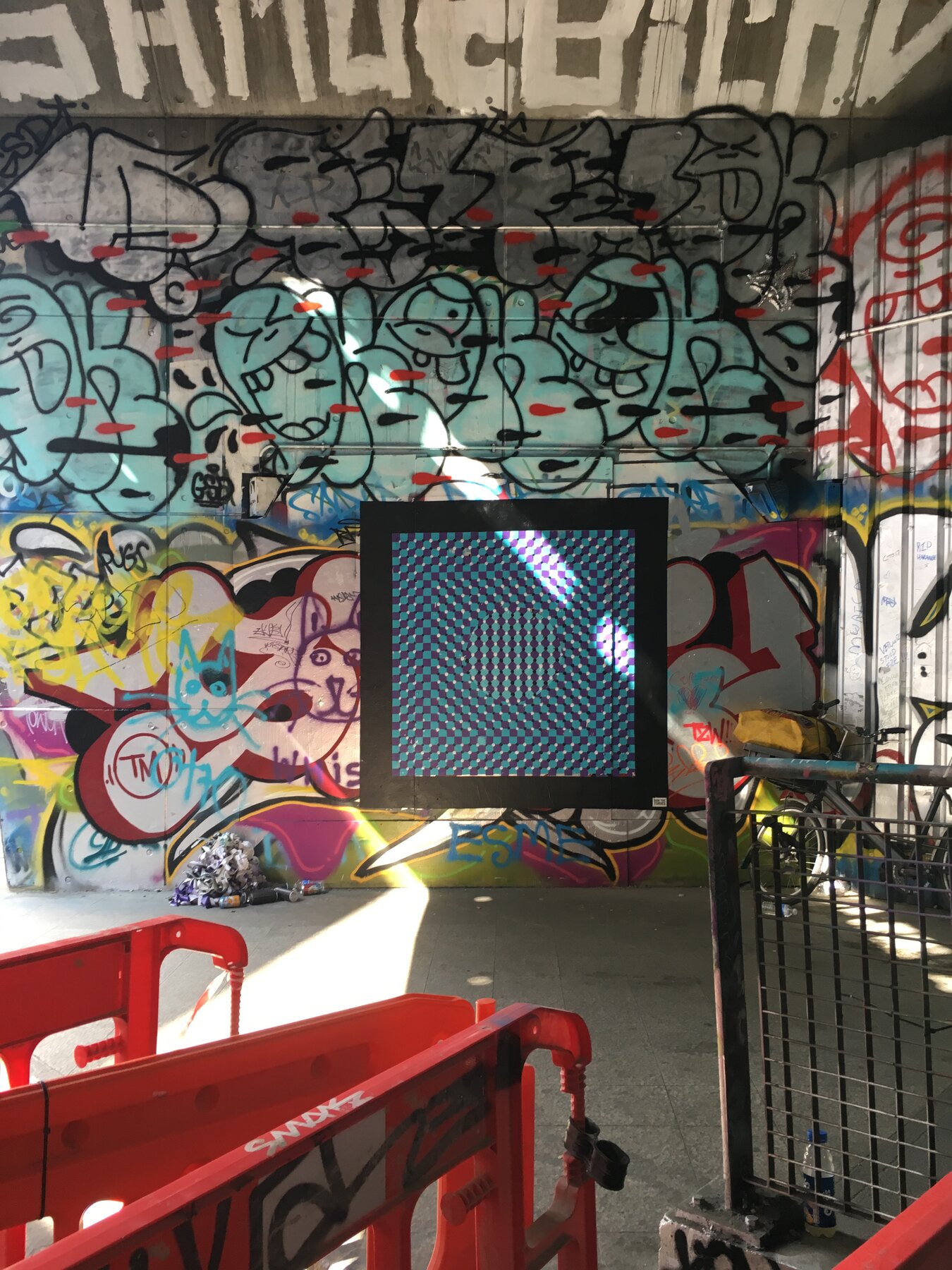 The Leake Street tunnel with the op-art mural among other artists work and painting equipment