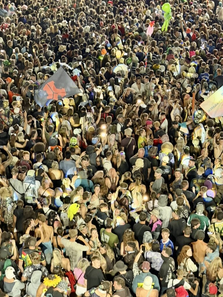 Looking straight down onto a dense crowd from the cherry picker at the back of the field