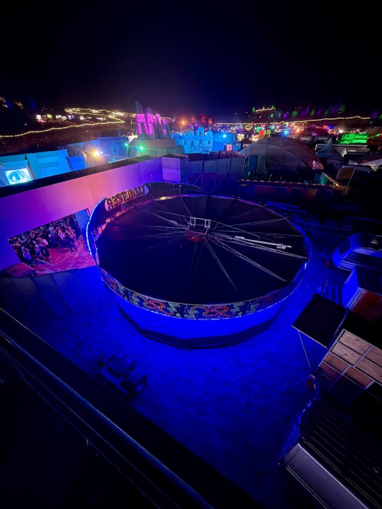 The festival site at night from the cherry picker, stage structures and lighting laid out below